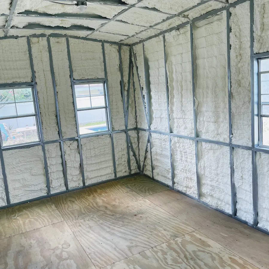 Closed-cell spray foam insulation applied to wall cavities in a residential project in Westbury